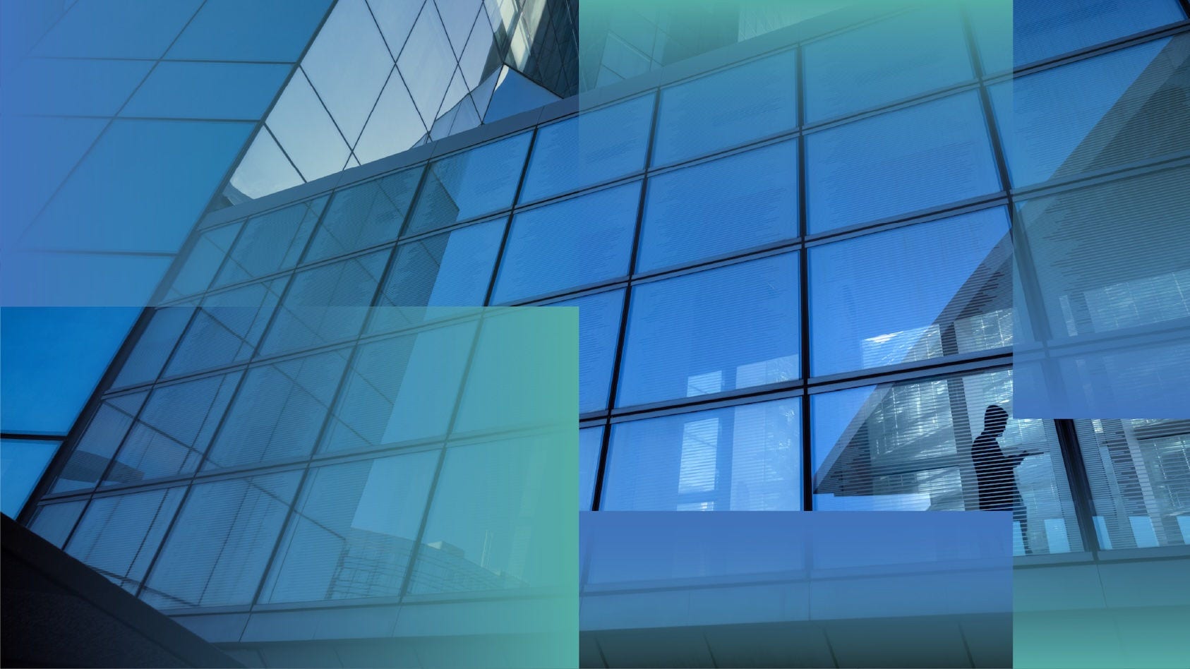 Exterior of an office building where a silhouette of a business person can be seen.